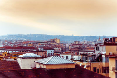 High angle view of cityscape against cloudy sky