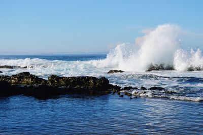 Scenic view of sea against clear sky with epic wave