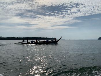 Boat sailing in sea against sky