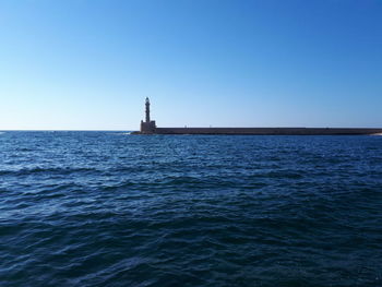 Scenic view of sea against clear blue sky