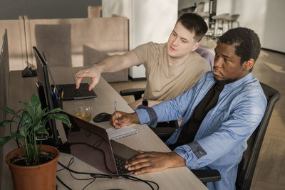 Two programmers working in the office of a software development company. coding technologies