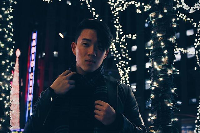 looking at camera, lifestyles, portrait, person, front view, young adult, casual clothing, leisure activity, focus on foreground, illuminated, smiling, standing, waist up, headshot, night, happiness, young men