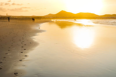 Scenic view of beach against sky during sunset