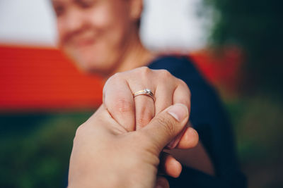 Midsection of couple holding hands