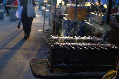Low section of person on barbecue grill at market