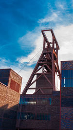 Low angle view of building against cloudy sky