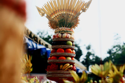 Low angle view of fruits on stand against sky