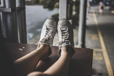 Low section of women sitting outdoors