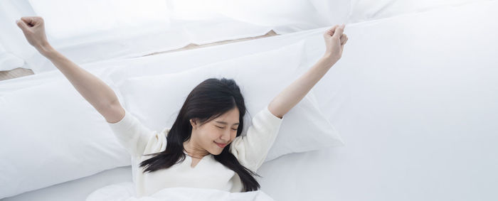 High angle view of woman lying on bed