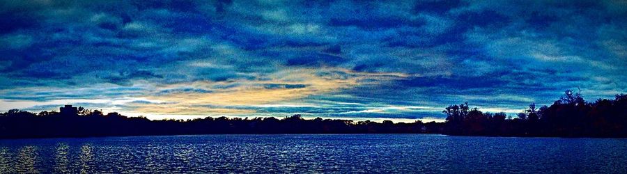 Scenic view of lake against cloudy sky