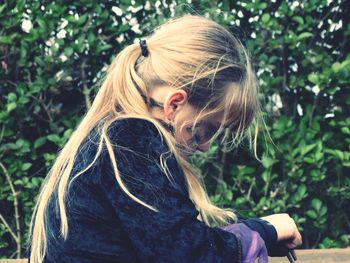 Side view of girl against plants