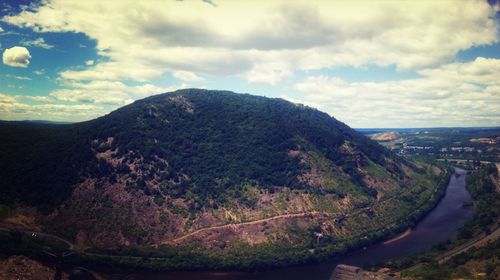 Scenic view of mountains against cloudy sky