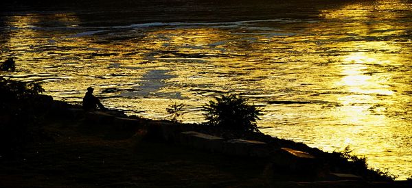 High angle view of silhouette beach against sky during sunset