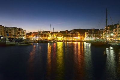 Boats in river with buildings in background