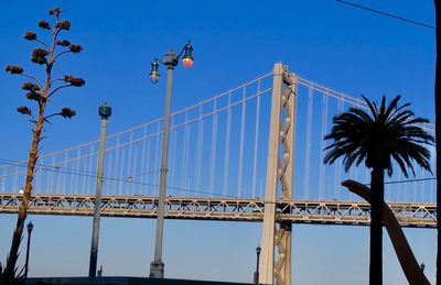 Low angle view of bridge against clear blue sky