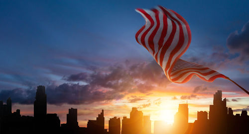 Silhouette buildings against sky during sunset