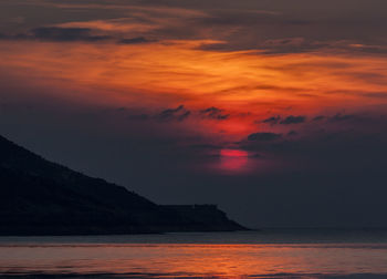 Scenic view of sea against romantic sky at sunset