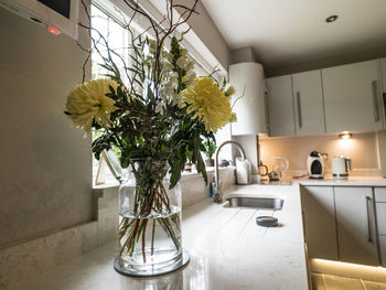 Flower vase on table at home