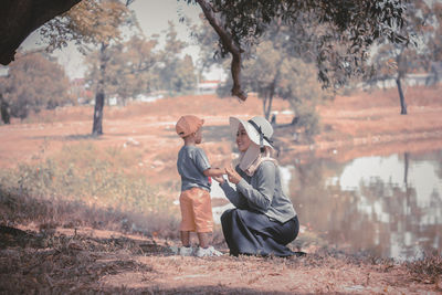 Side view of woman standing on field