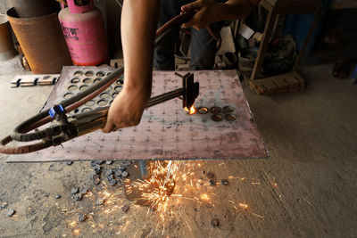 Low section of man working on floor