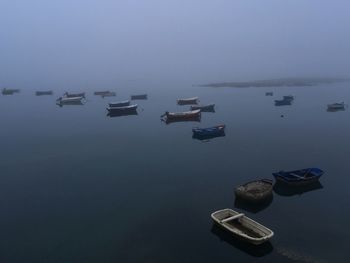 Boats on lake against sky