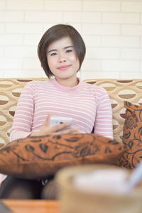 Portrait of a smiling girl sitting at home