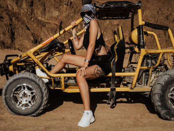 Full length of woman sitting on motorcycle