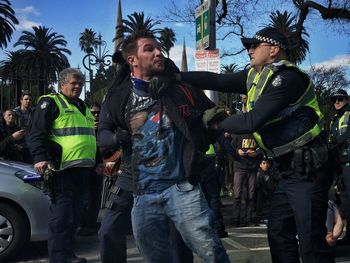 Full length of men standing against trees