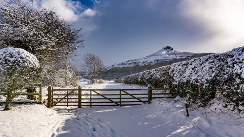 Snow covered landscape against sky