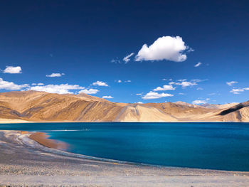 Scenic view of land against cloudy sky