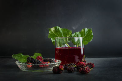 Various fruits in container against black background