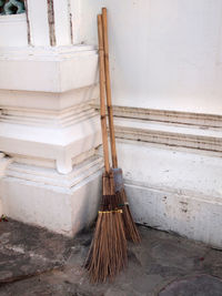 High angle view of broom against wall outdoors