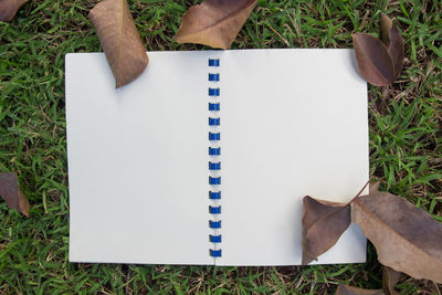 High angle view of open book on field