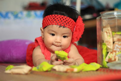 Portrait of cute baby girl on table