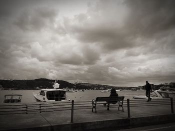 Silhouette of woman against cloudy sky