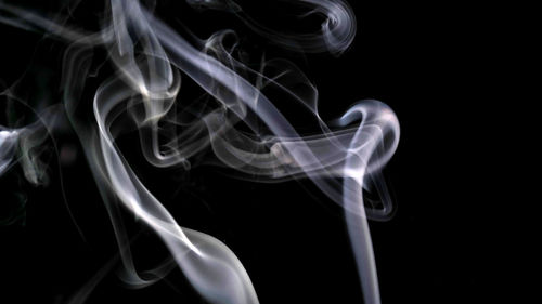 Close-up of smoke pattern against black background