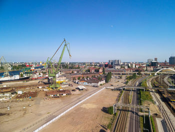 High angle view of city against clear blue sky