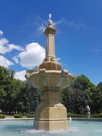 Statue of fountain against blue sky