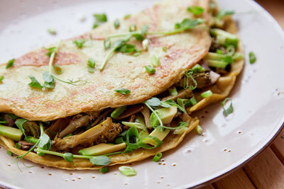 Alternative vegan pancakes filled with mushrooms, pea sprouts, avocado. healthy breakfast