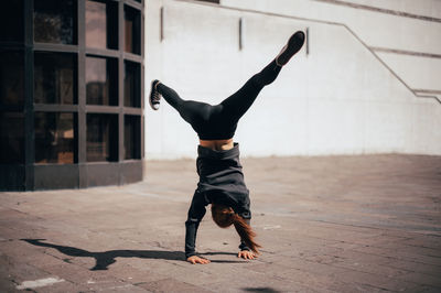 Full length of woman exercising outdoors