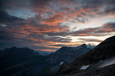 Scenic view of snowcapped mountains against sky during sunset