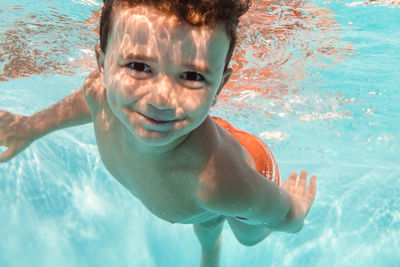 Portrait of boy swimming in pool