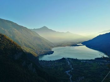 Scenic view of river and mountains against clear sky