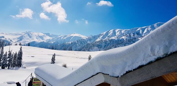 Scenic view of snow covered mountains against sky