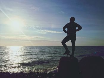 Man standing at beach against sky