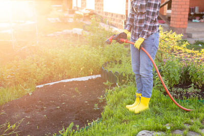 Man holding umbrella in yard