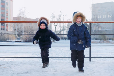 Children playing in snow. happy children rejoice in winter. winter games in the snow.