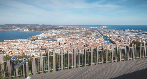 High angle view of townscape by sea against sky