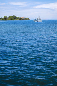 Sailboat sailing in sea against sky