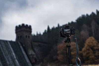 Low angle view of camera against sky